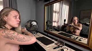 Tattooed blonde does hair and makeup naked