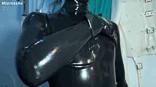 solo 1 showcasing studio black latex catsuit and huge red cobra strap-on