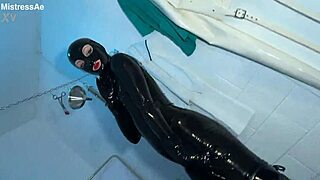 solo 1 showcasing studio black latex catsuit and huge red cobra strap-on
