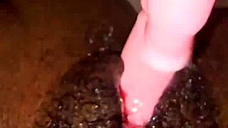 Ebony creams her pussy while squirting